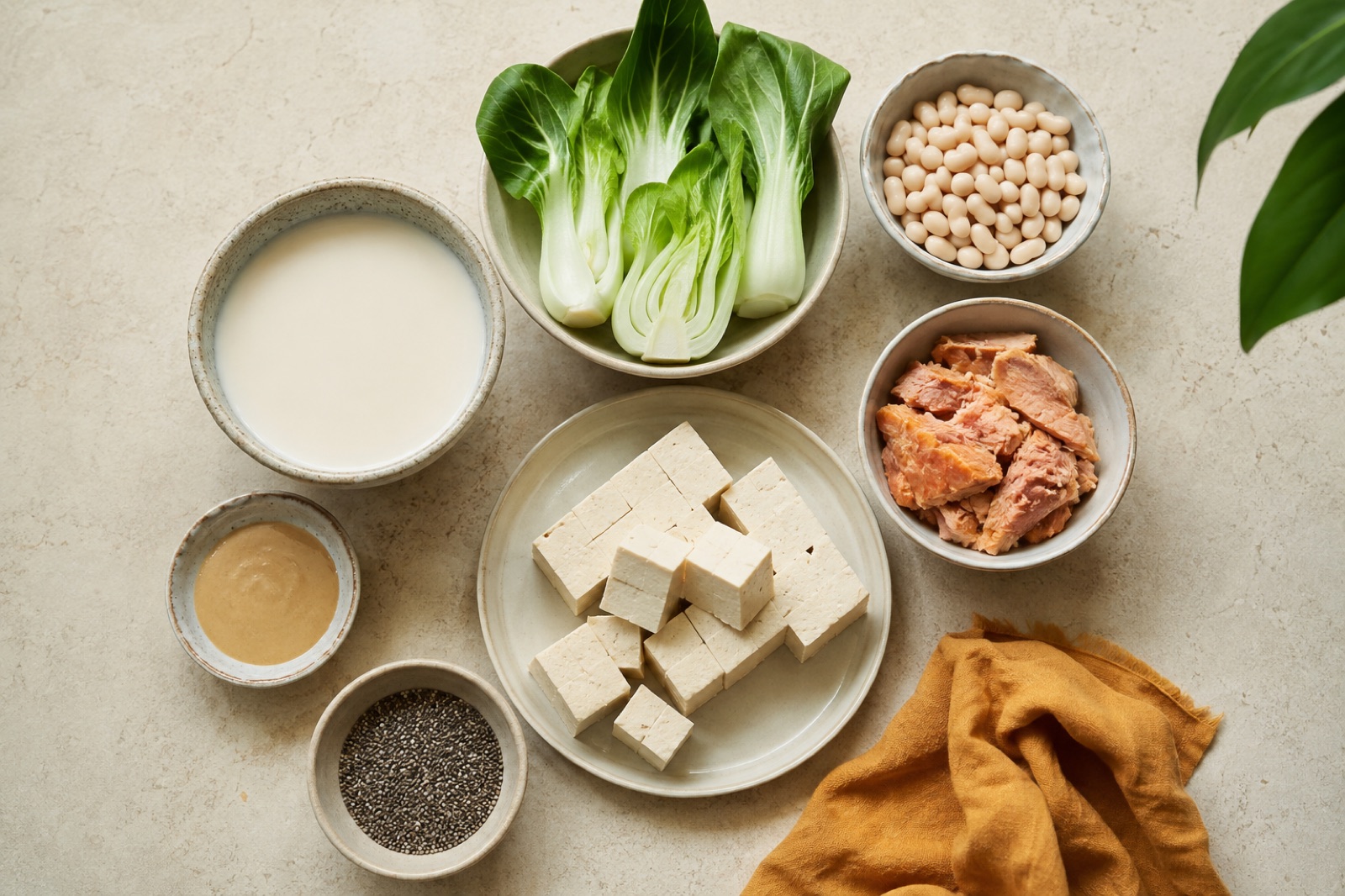 Colorful array of fresh dairy-free alternatives including oat milk, coconut yogurt, and vegan cheese
